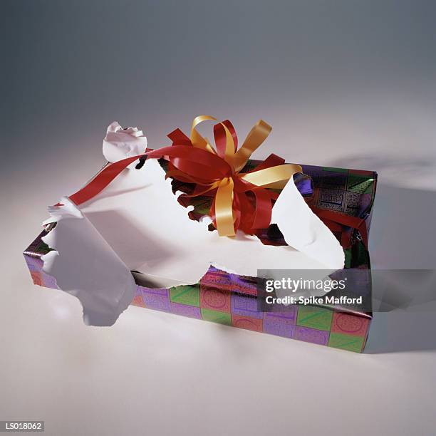 torn wrapping on gift - torn gift stock pictures, royalty-free photos & images