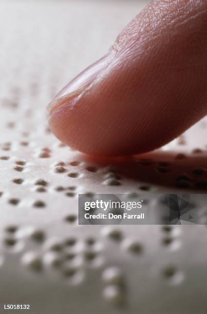 finger on braille - braille stock pictures, royalty-free photos & images