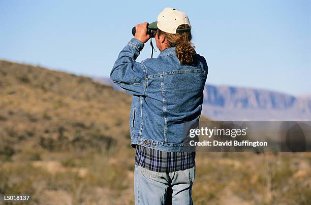 man looking through binoculars - chihuahua desert stock pictures, royalty-free photos & images
