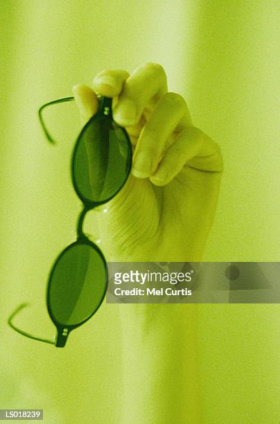 holding sunglasses - curtis stock pictures, royalty-free photos & images