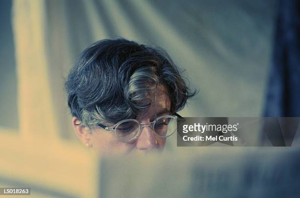 woman reading newspaper - curtis stock pictures, royalty-free photos & images