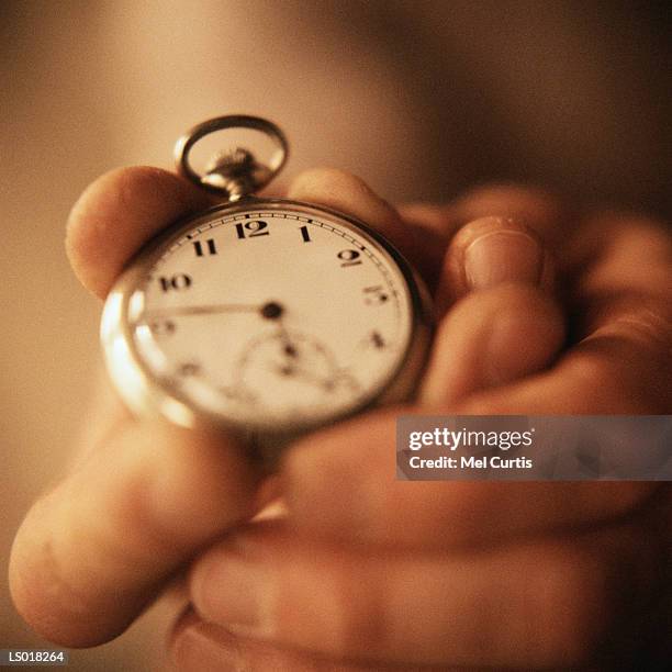 holding pocket watch - curtis stockfoto's en -beelden