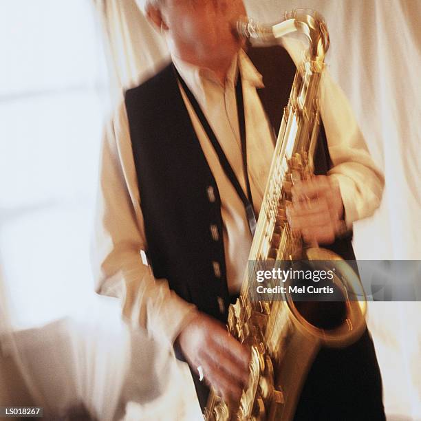 playing saxophone - bläser stock-fotos und bilder