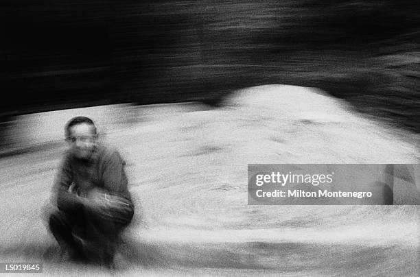 man sitting on curb - ancine stockfoto's en -beelden