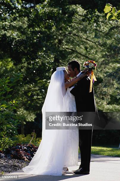 bride and groom kissing - black veil brides stock pictures, royalty-free photos & images