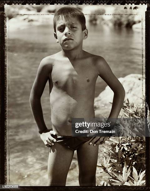 boy standing by river - speedo boy stock pictures, royalty-free photos & images