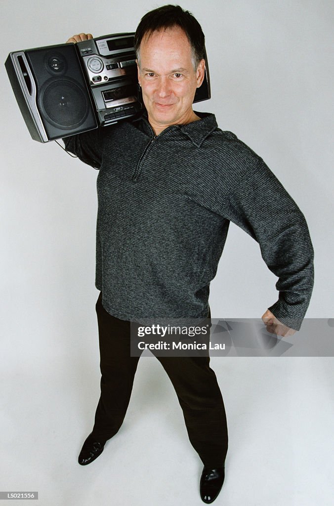 Smiling Man Holding a Boom Box