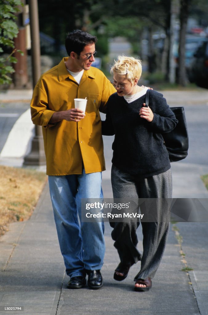 Couple Walking Down a Sidewalk