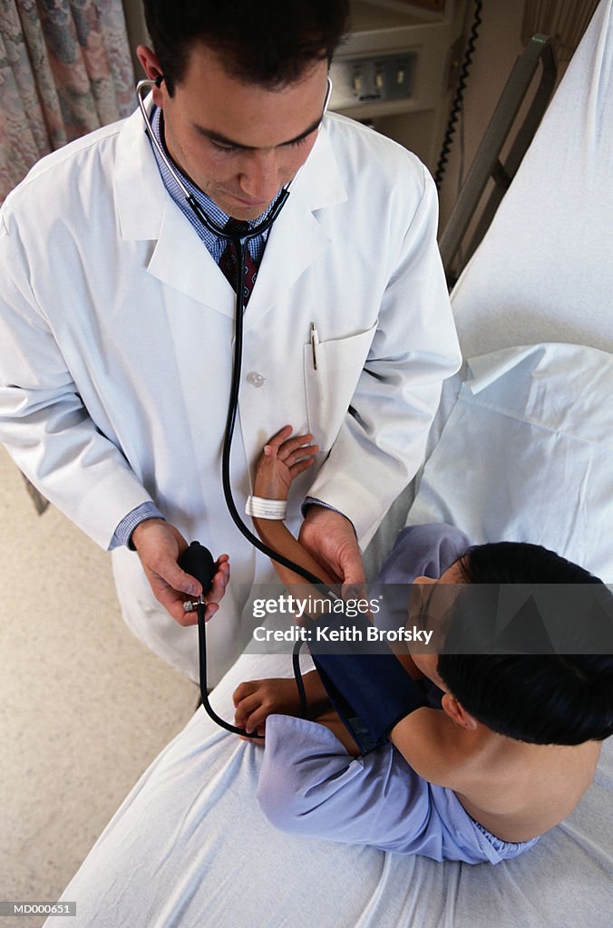 Doctor Taking a Boy's Blood Pressure