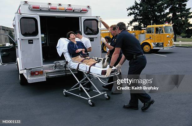 wheeling woman into ambulance - 4 wheeling stock pictures, royalty-free photos & images
