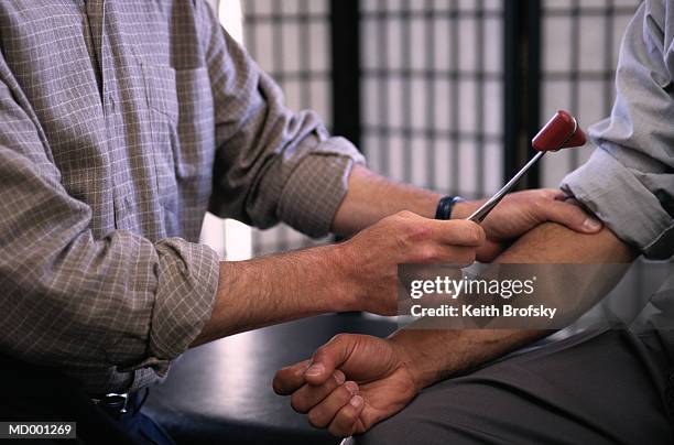 man getting checkup - reflex hammer stock pictures, royalty-free photos & images