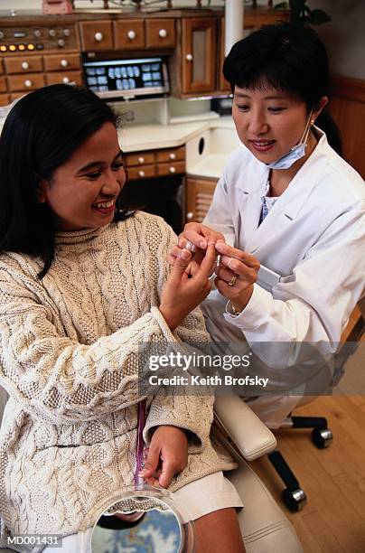 dentist teaching patient how to floss - why how stock pictures, royalty-free photos & images