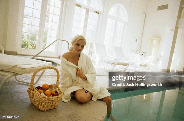woman sitting by a swimming pool at a spa - balneotherapy stock pictures, royalty-free photos & images
