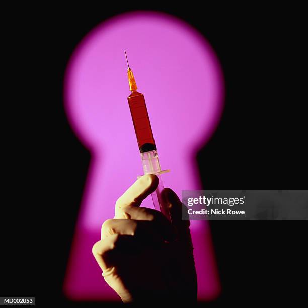 syringe through keyhole - nick stock pictures, royalty-free photos & images