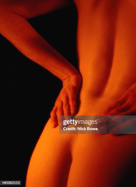 woman with lower back pain - nick stock-fotos und bilder