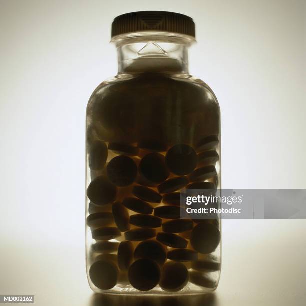 silhouette of aspirin bottle - aspirin imagens e fotografias de stock