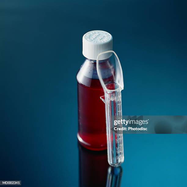 medicine bottle with child's dispenser - cough medicine stock pictures, royalty-free photos & images