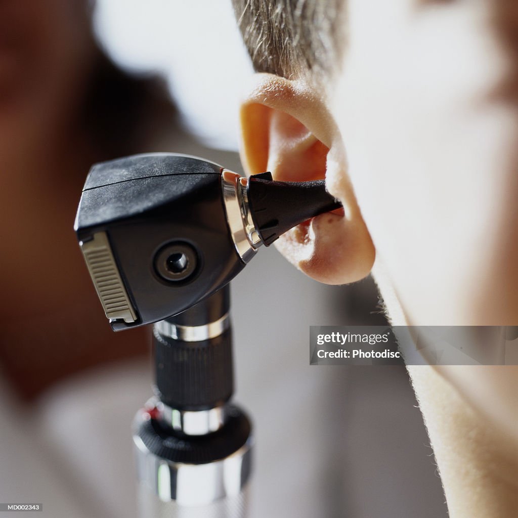 Otoscope in Person's Ear