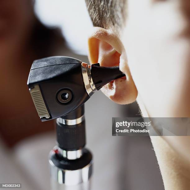 otoscope in person's ear - otoscope bildbanksfoton och bilder