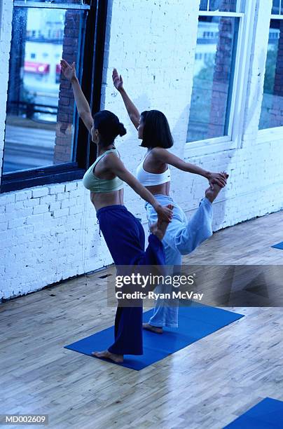 yoga instructor and student doing yoga - lord of the dance pose stock pictures, royalty-free photos & images