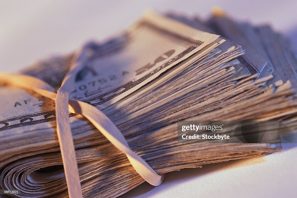 Roll of paper money bound with rubber band