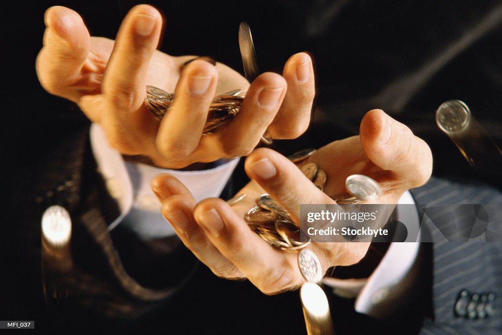 Hands catching coins