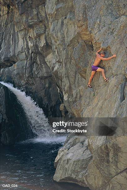 man rock-climbing - soloing stock pictures, royalty-free photos & images