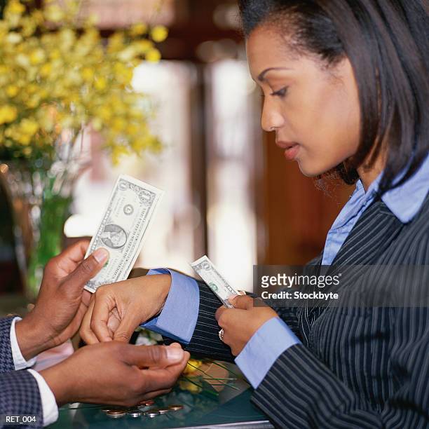 woman counting money into man's hands - commercial event stockfoto's en -beelden