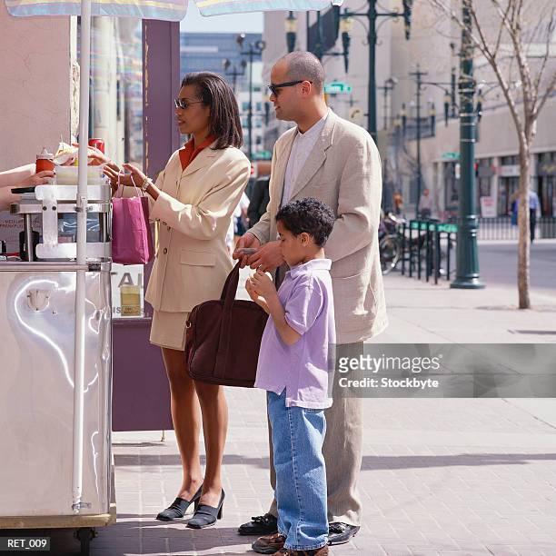 family buying food from street vendor - hot dog stand ストックフォトと画像