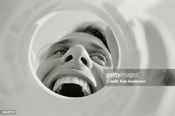 man looking through funnel, mouth open, close-up (b&w) - the uk gala premiere of w e after party stockfoto's en -beelden