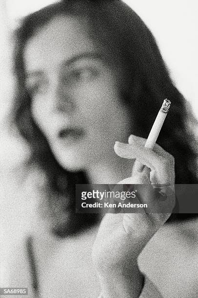 young woman smoking cigarette, close-up (b&w) - the uk gala premiere of w e after party stockfoto's en -beelden