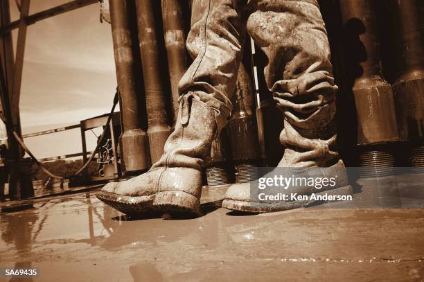 oil worker wearing muddy boots, close-up (b&w) - bronwen smith of b floral and the today shows lilliana vazquez host a private floral accessories event in nyc stockfoto's en -beelden