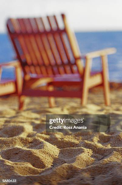 deck chair on beach, rear view (focus on sand) - ross stockfoto's en -beelden