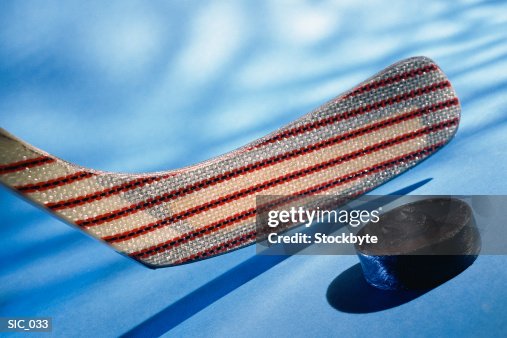 Blade of hockey stick and puck Blade of hockey stick and puck