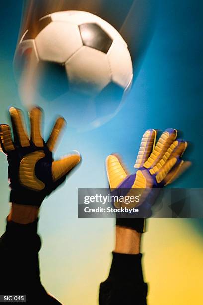 goalkeeper's hands reaching out to soccer ball - soccer goalkeeper stock pictures, royalty-free photos & images