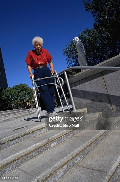 woman with walker on steps - step walker stock-fotos und bilder