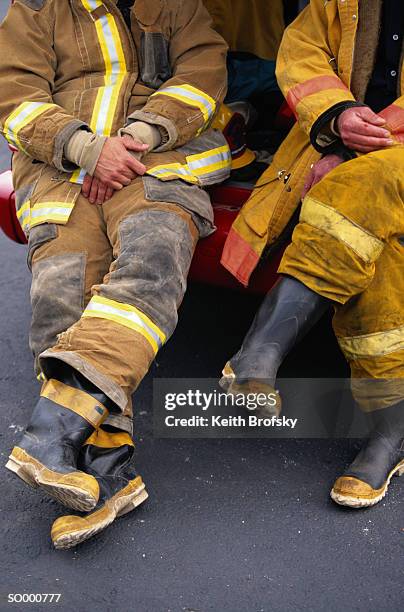 firefighters sitting - firefighter boot stock pictures, royalty-free photos & images