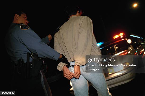 making an arrest - restraining device stock pictures, royalty-free photos & images