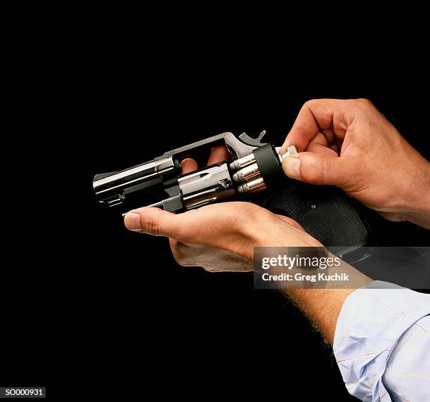 loading a revolver - greg stock pictures, royalty-free photos & images