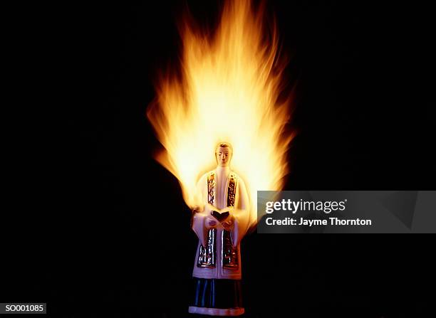 burning priest figurine - thornton stock pictures, royalty-free photos & images