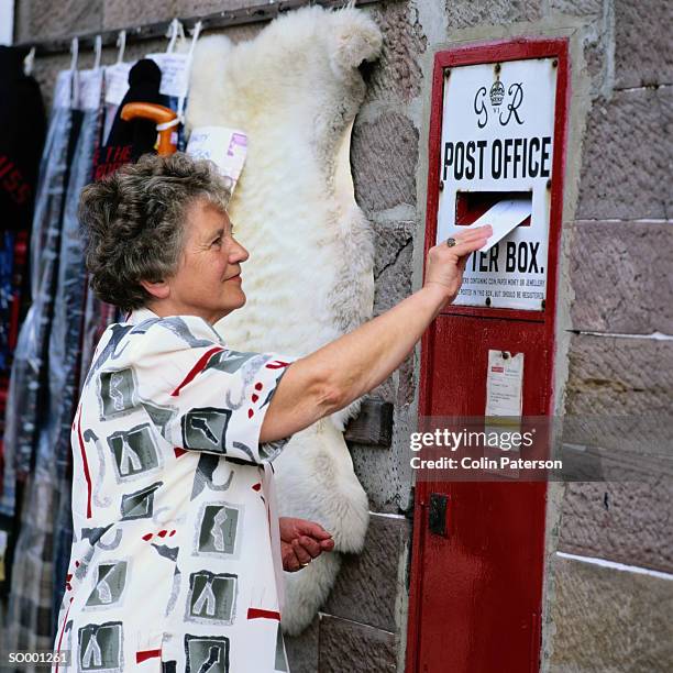 woman mailing a letter - letter bildbanksfoton och bilder