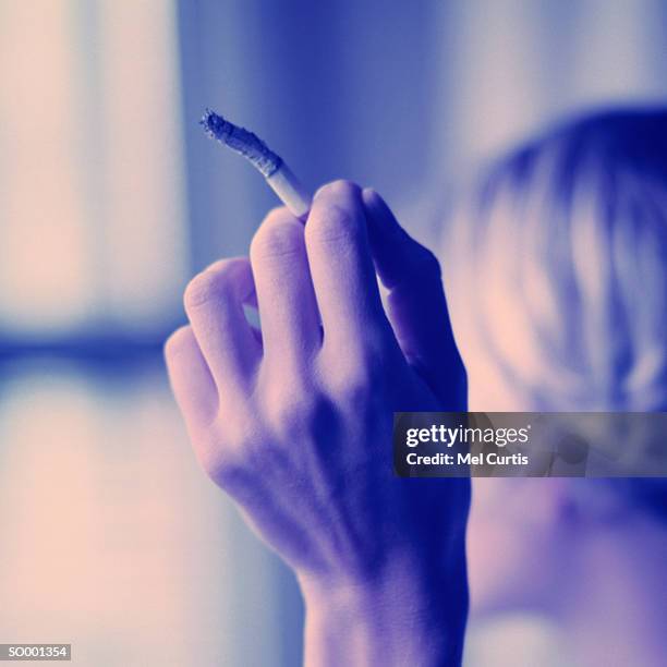 holding cigarette - curtis stock pictures, royalty-free photos & images