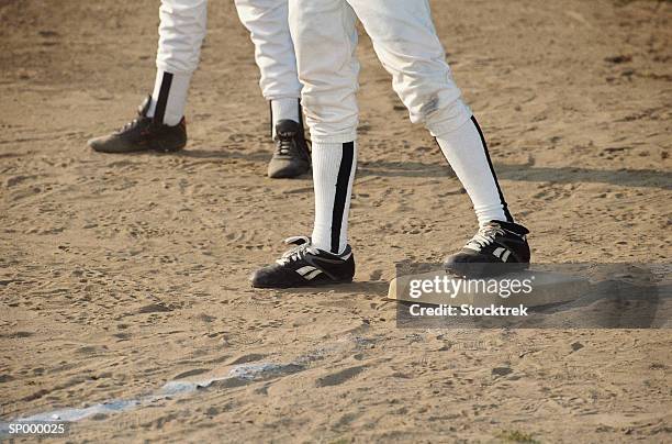 shot of legs and base in little league - base sports equipment stockfoto's en -beelden