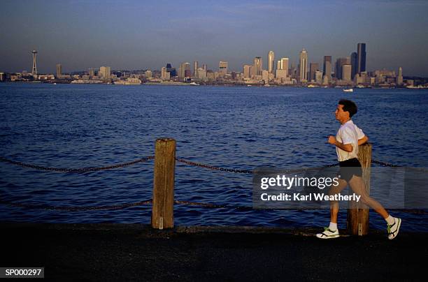 man running by water - north pacific ocean stock pictures, royalty-free photos & images