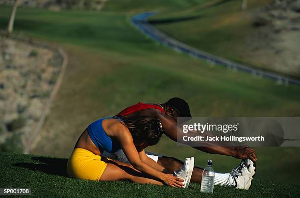 man and woman stretching - jack and jack stock pictures, royalty-free photos & images