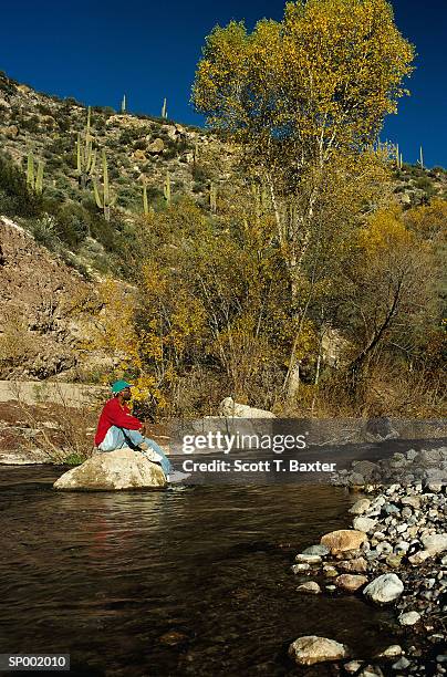 hiker resting in creek - scott stock pictures, royalty-free photos & images