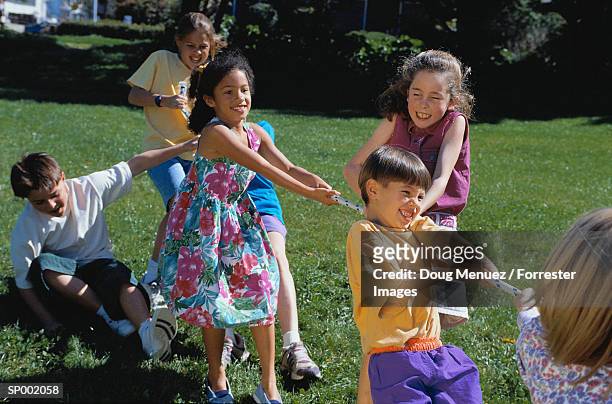 children playing tug of war - war stock-fotos und bilder