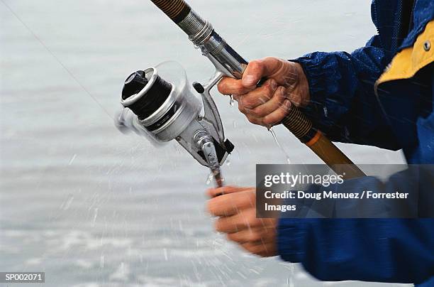 fishing with a rod and reel - fishing reel foto e immagini stock