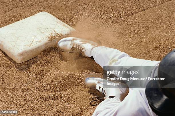 baseball player sliding into base - sliding door stockfoto's en -beelden