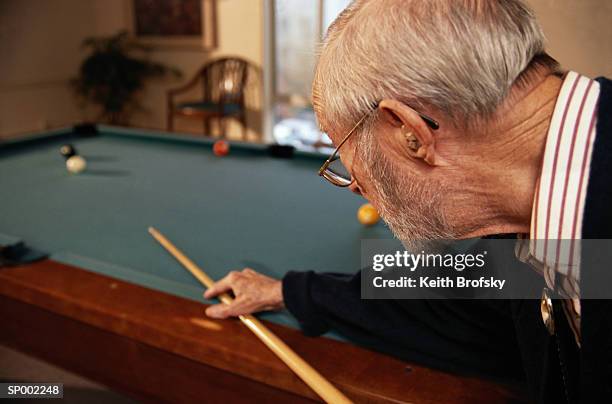 man playing pocket billiards - only-senior-men stock pictures, royalty-free photos & images